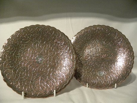 A pair of brass Islamic plated with inlaid silver design